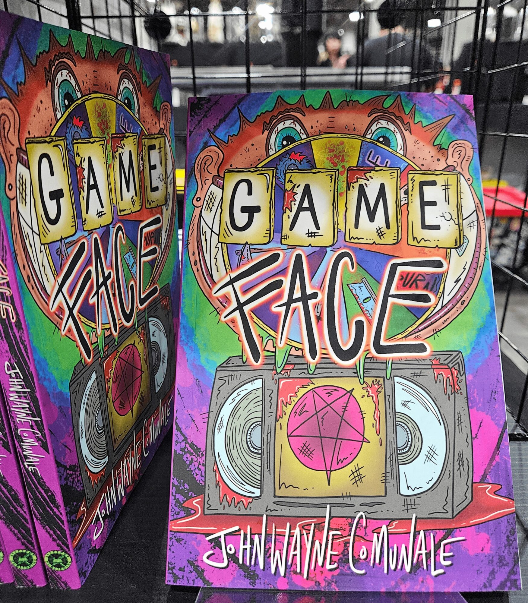 Colorful game box with face and boombox illustration, text 'GAME FACE' and 'JOHANNE C. MUNATE', vibrant background.