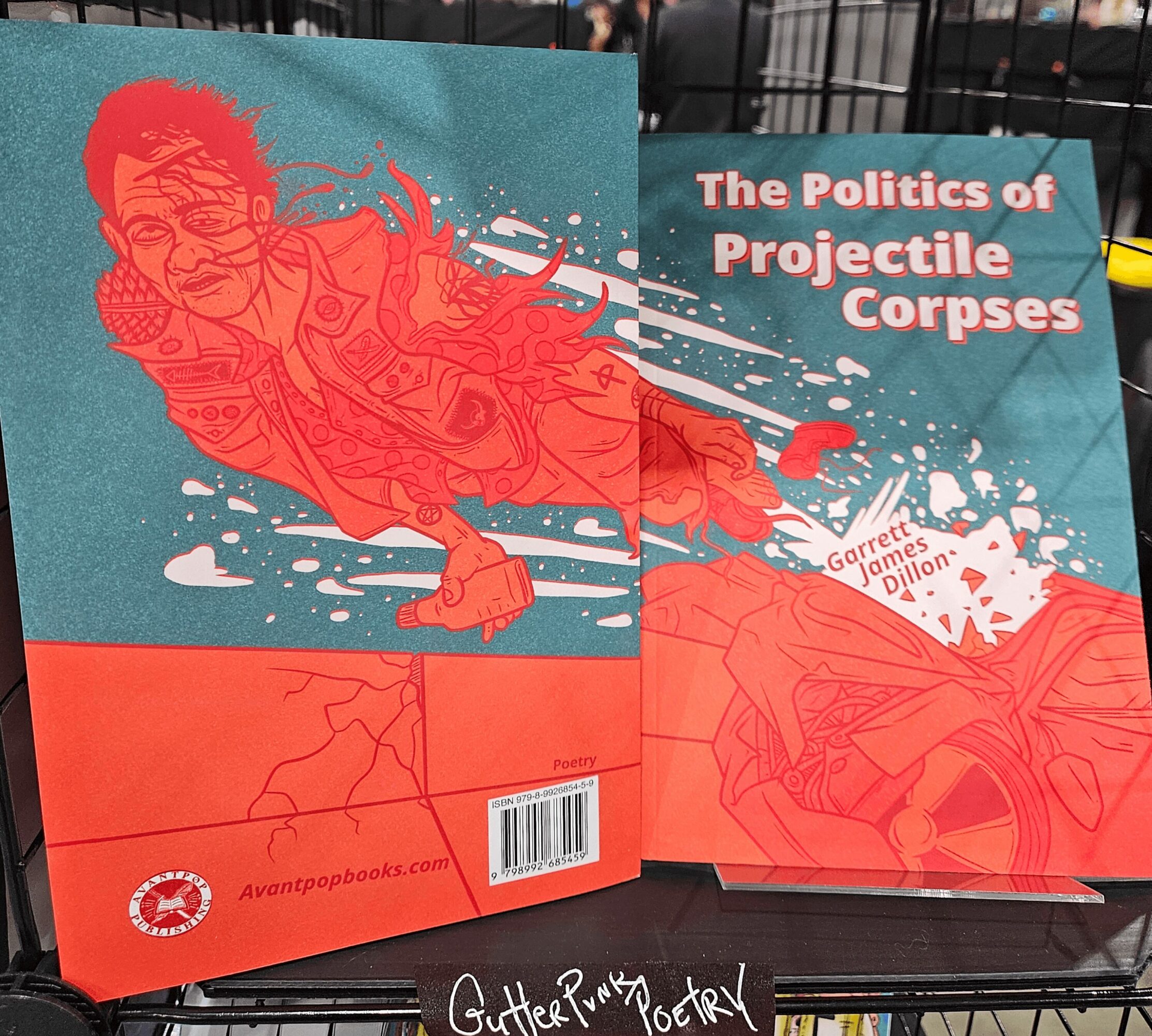 Book cover titled 'The Politics of Projectile Corpses' with an illustration of a person in red and white, and a barcode.