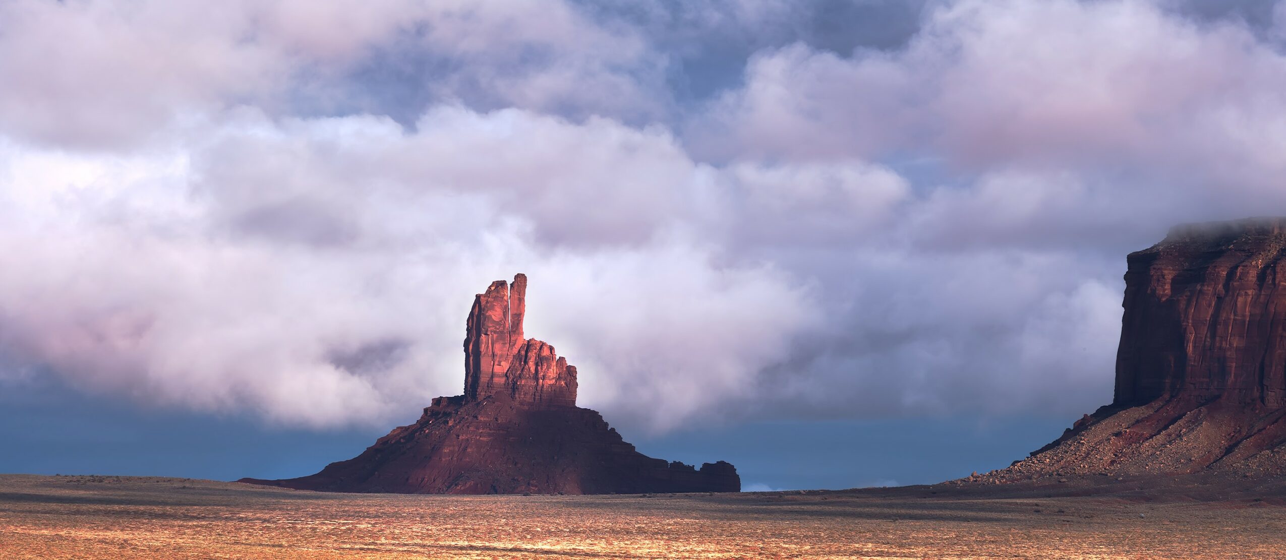 Rock formation in a desert landscape with cloudy sky