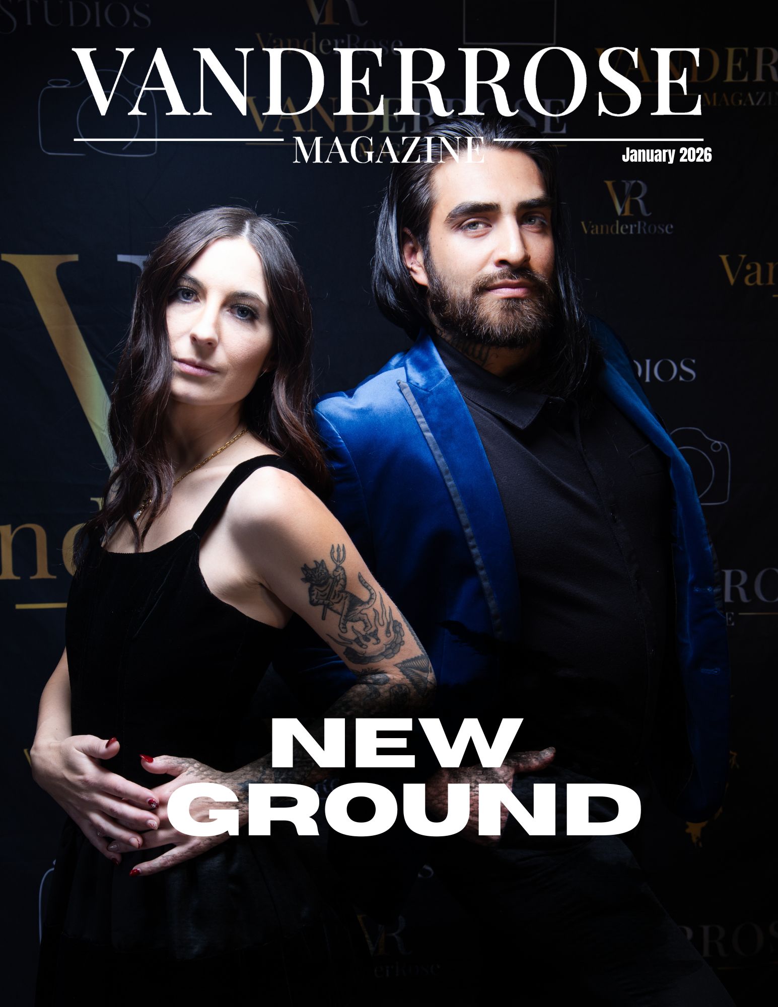 Magazine cover featuring a woman with long dark hair and a tattoo, and a man with a beard, both dressed in dark clothing.