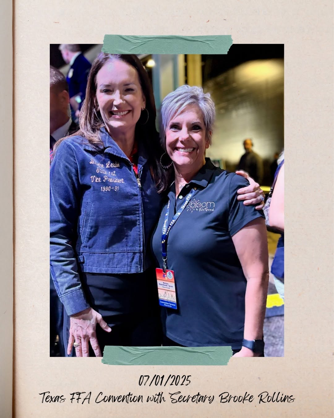 Two women smiling, one with long hair and the other with short gray hair, standing close together at an event.