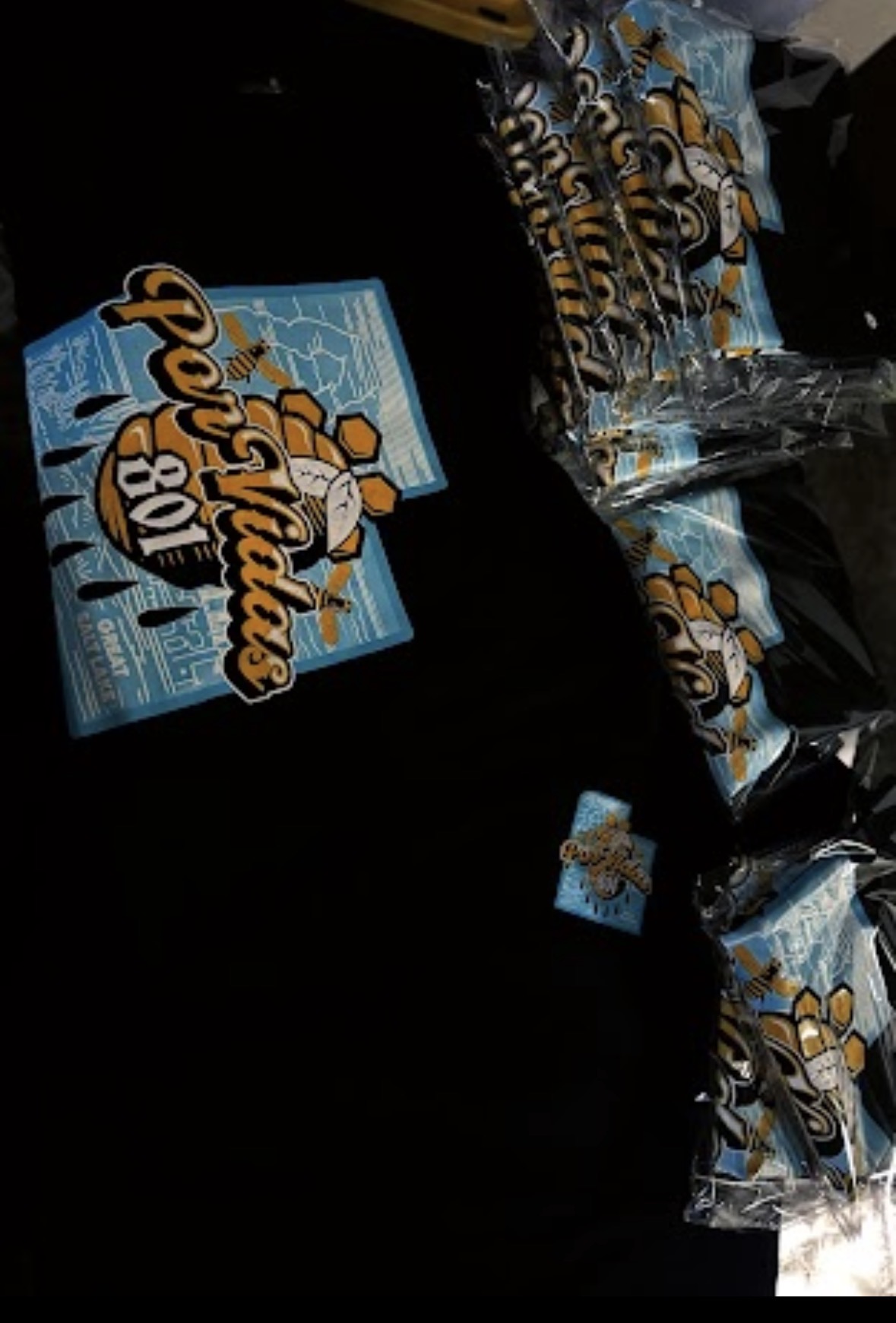 Stack of snack bags and a box with a cartoon character, on a dark surface.