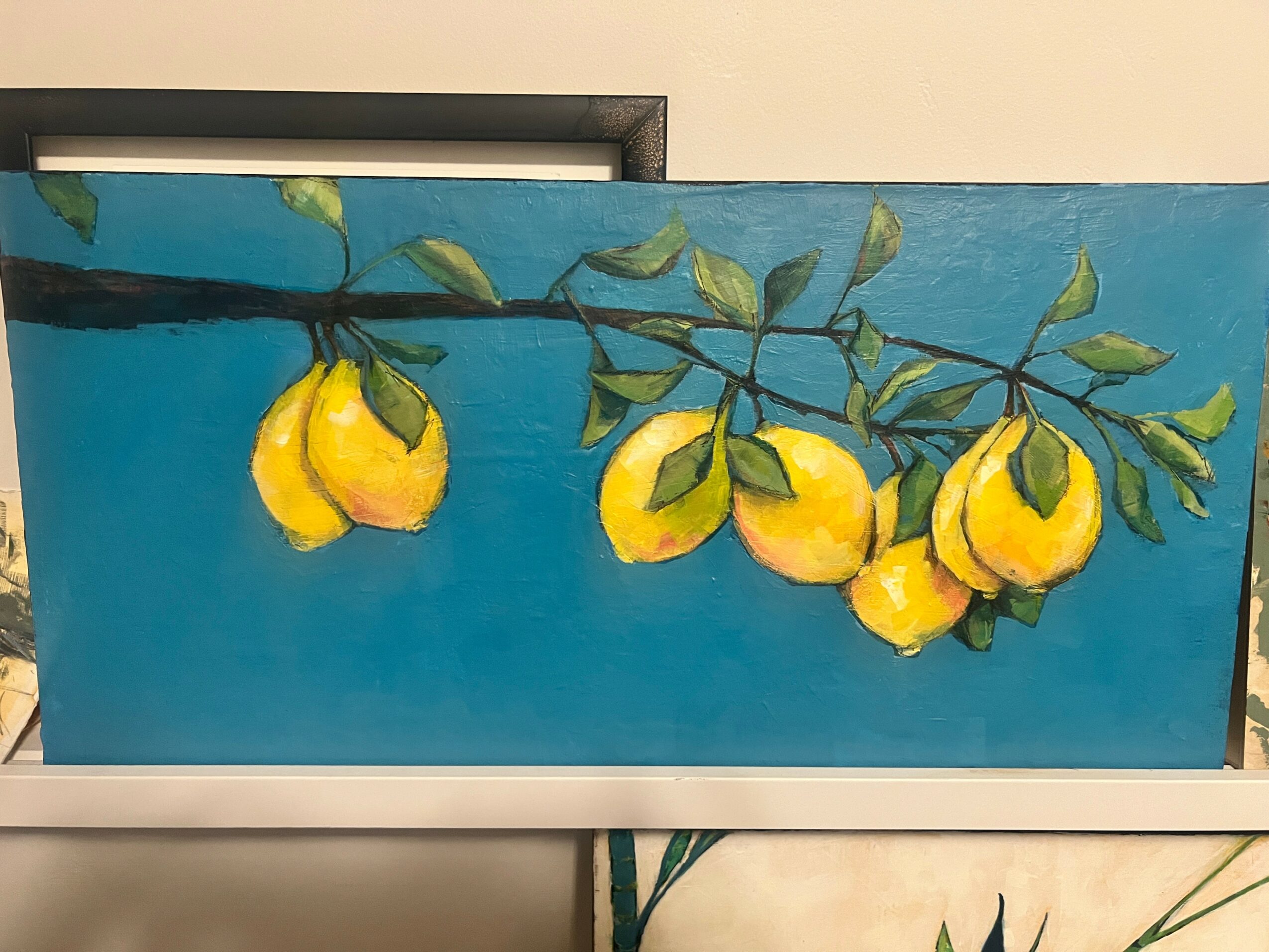 Painting of a branch with yellow lemons and green leaves against a blue background.