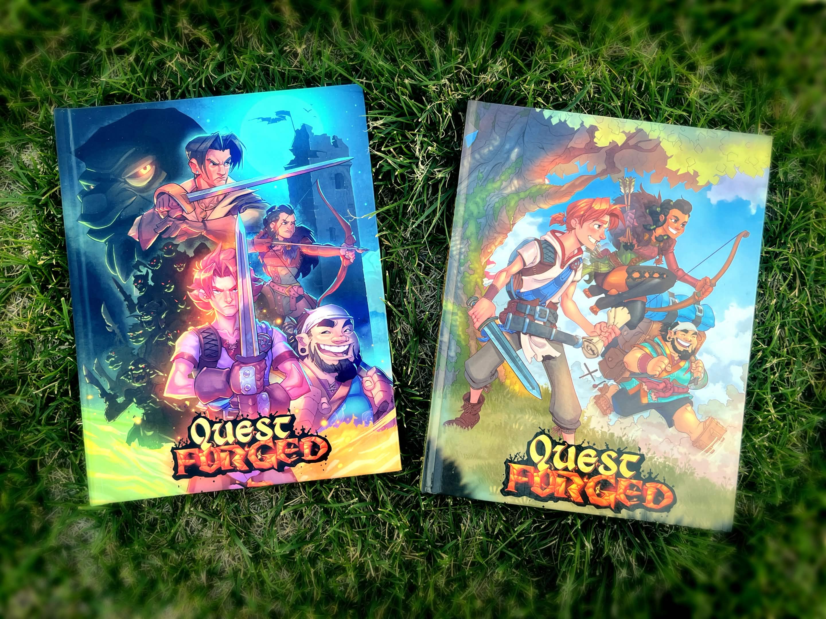 Two colorful Quest Forger board game boxes on grass, featuring fantasy characters and vibrant artwork.