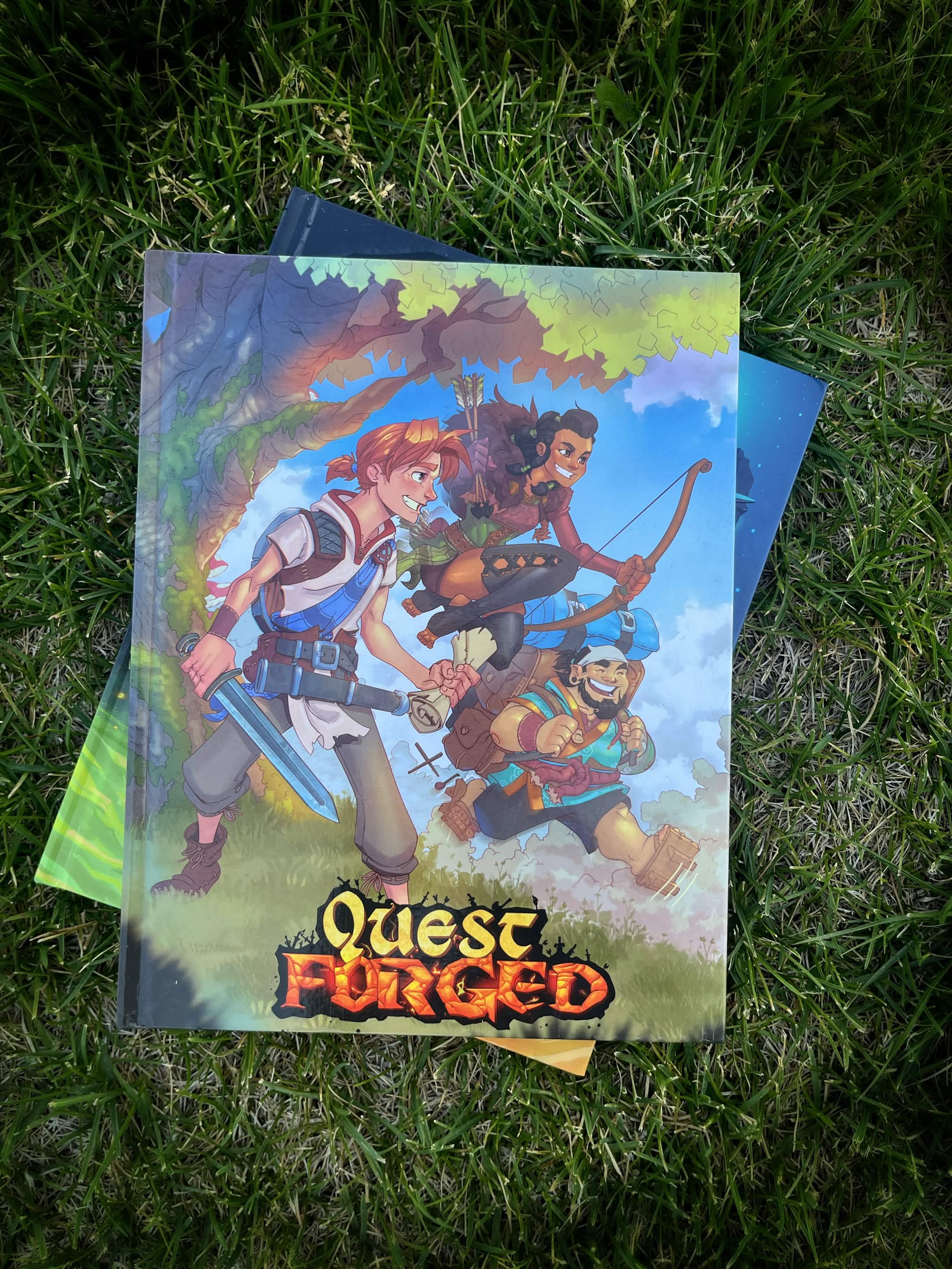 Three characters with weapons stand outdoors with a cloudy sky background, and the title 'Quesa Forged' at the bottom.
