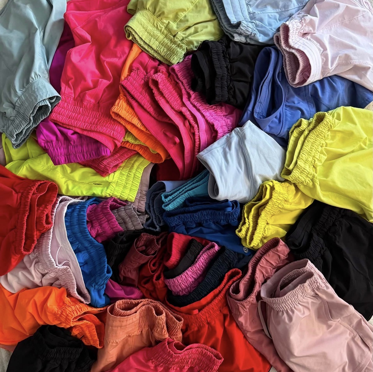 Colorful pile of folded and crumpled socks in various colors and sizes.