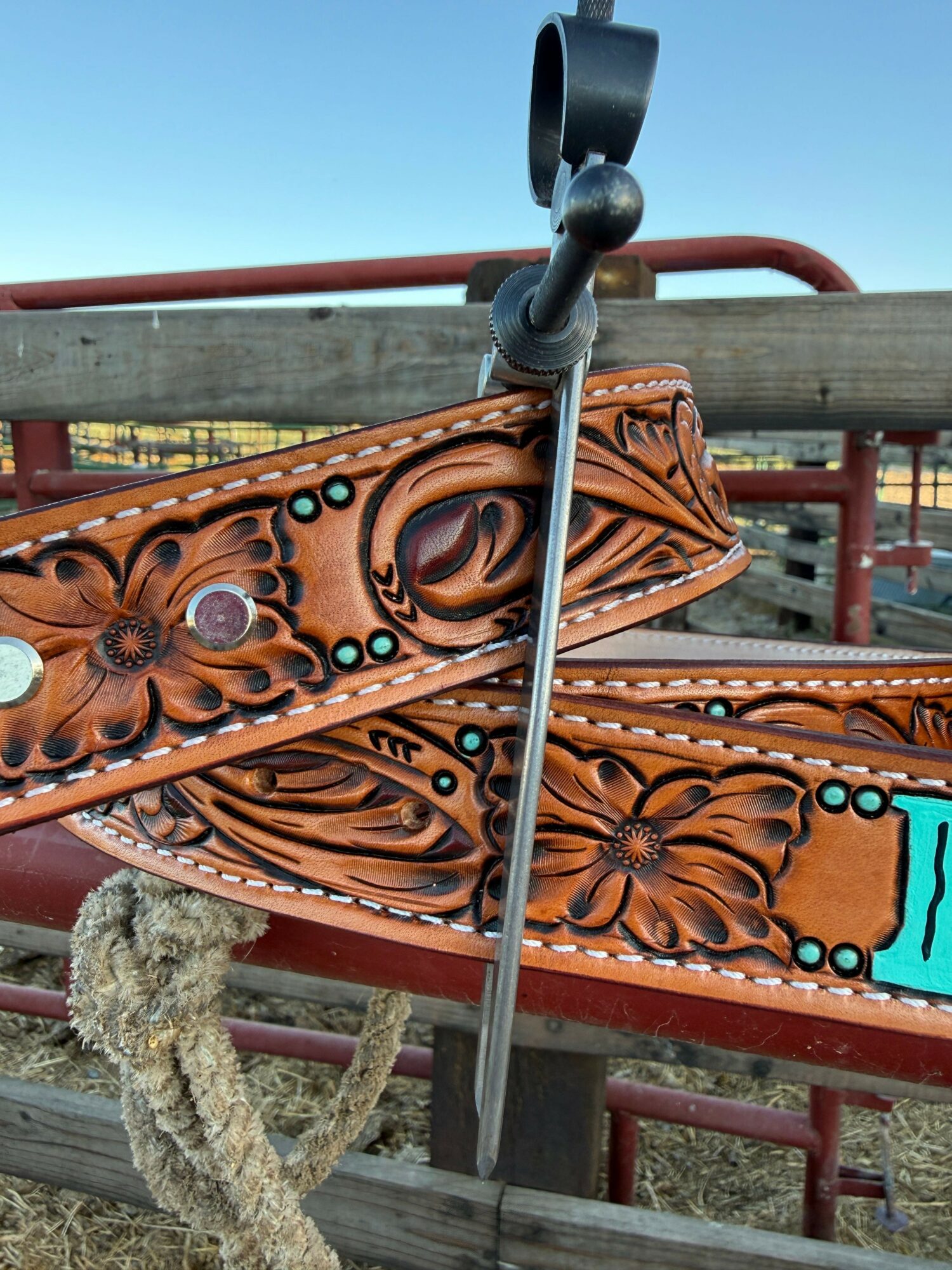 Close-up of a decorative wooden panel with floral carvings and colorful accents, part of a playground structure.