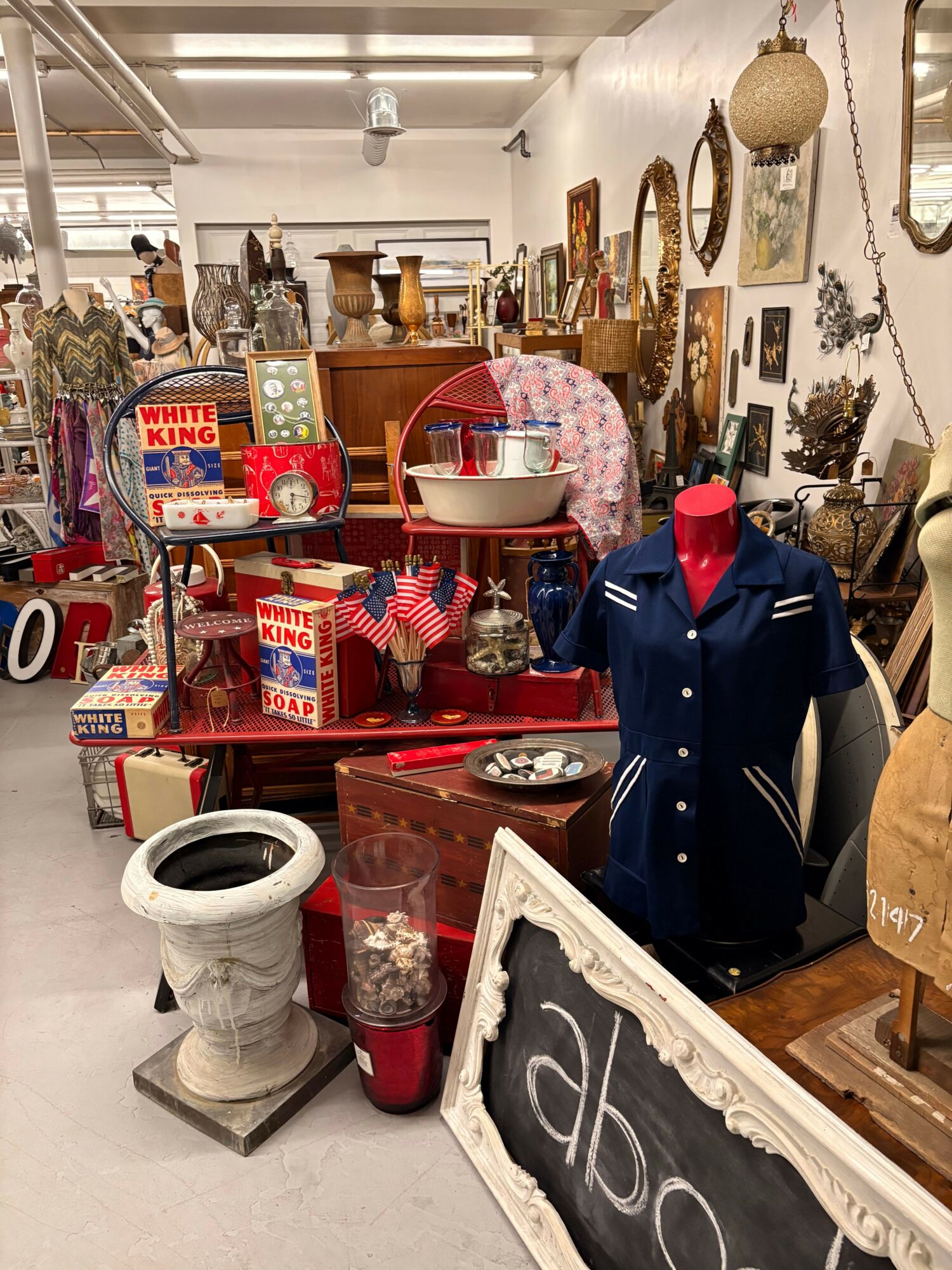 Display of vintage and decorative items including a red and white striped box, a small American flag, and various ornaments.