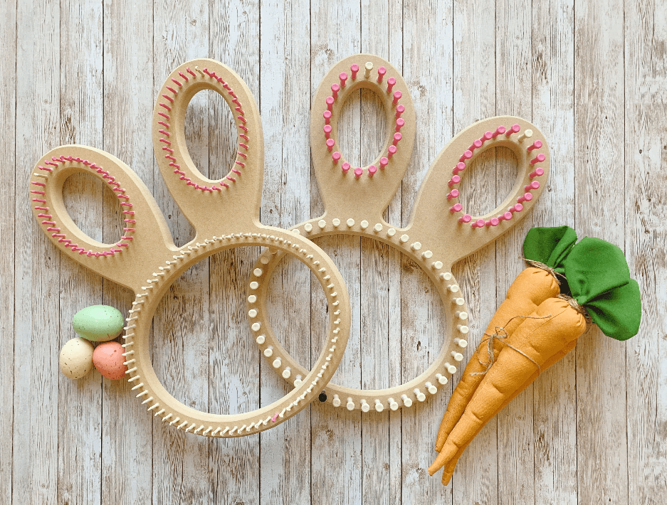 Colorful plastic hair rollers, two bracelets, and a toy carrot with green leaves on a wooden surface.