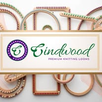 Close-up of colorful knitting loom tools with a sign reading 'Eindwood Premium Knitting Looms'.