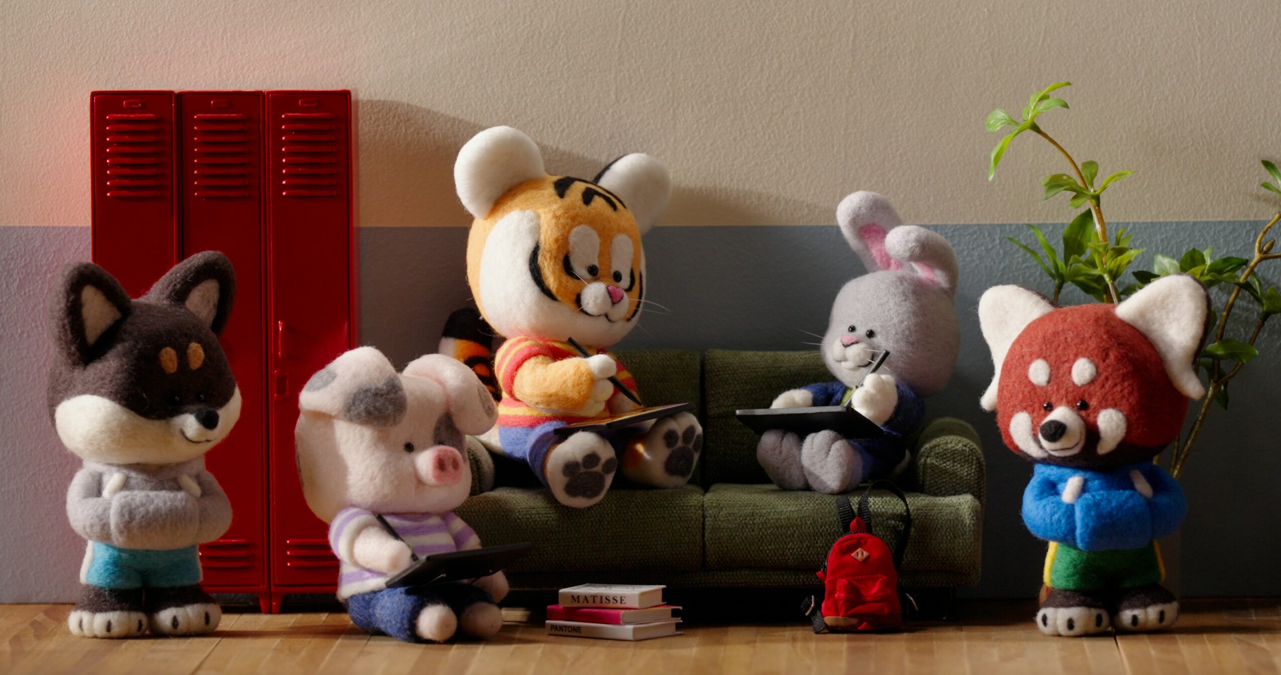 Five plush animal characters with large heads and small bodies in a room with a red locker, a green sofa, and a plant.