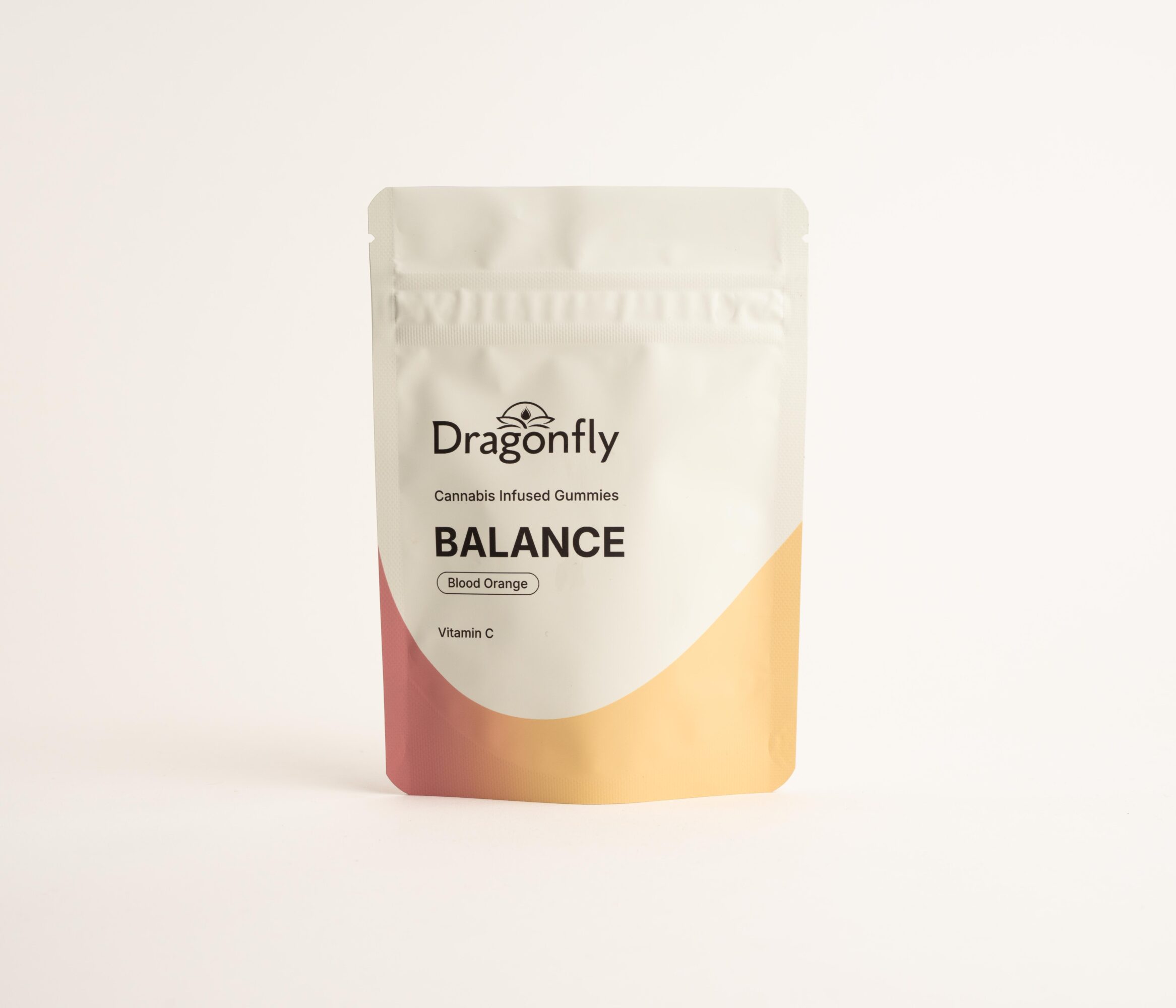 Package of Dragonfly cannabis-infused gummies labeled 'Balance' with a white, beige, and pink design, standing upright on a white background.