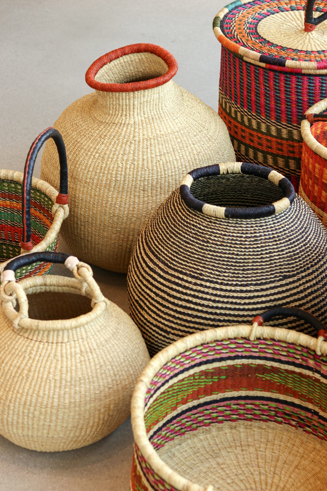 Several woven baskets with colorful patterns and different shapes are displayed together.