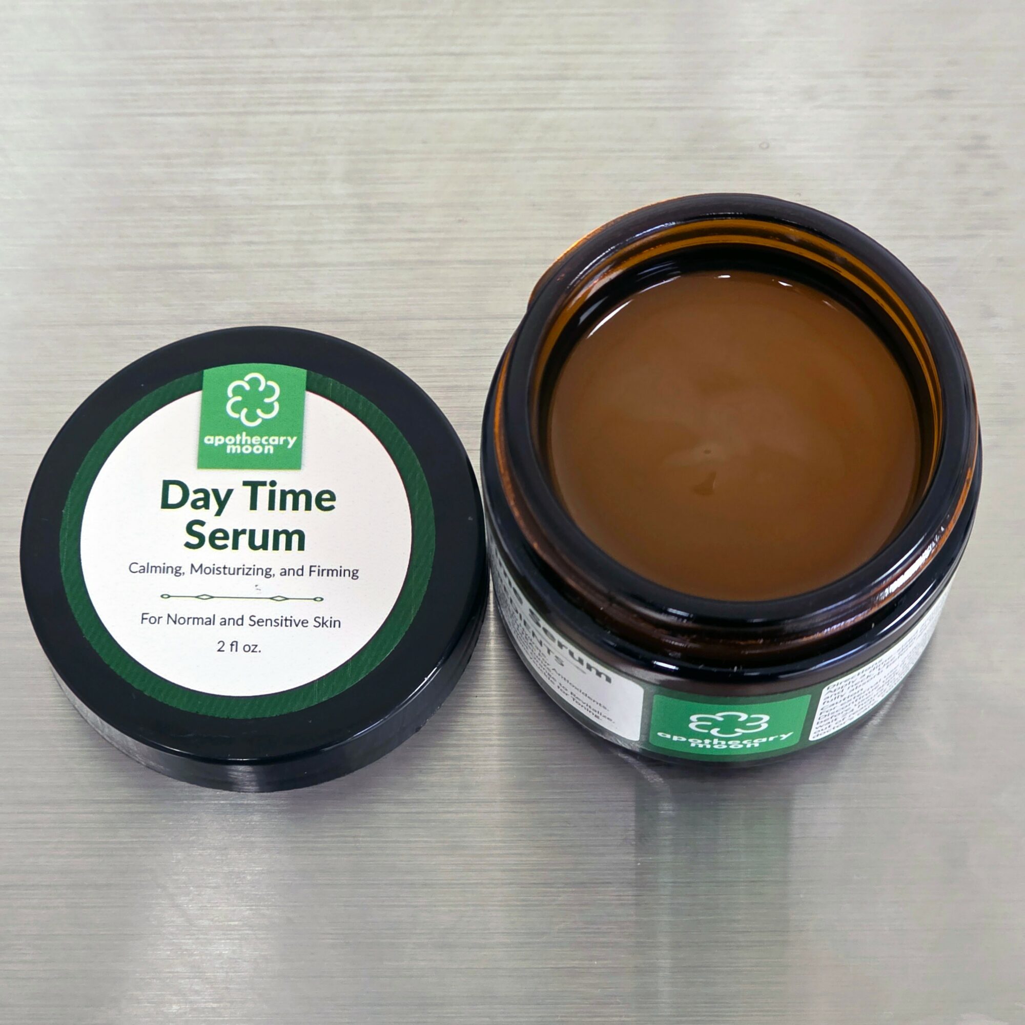 Open jar of Day Time Serum with brown gel inside, placed on a light-colored surface.