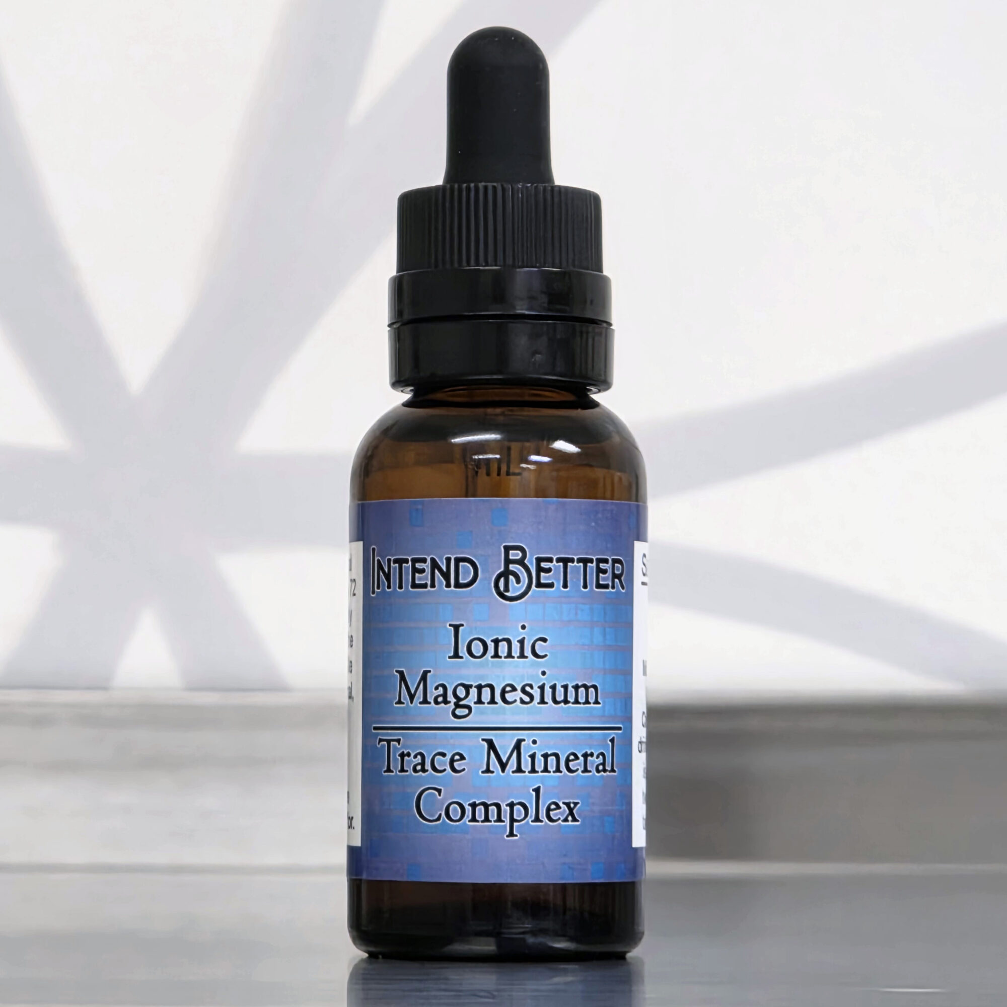 Small brown bottle with a black dropper cap, label reads 'Intend Better Ionic Magnesium Trace Mineral Complex'.